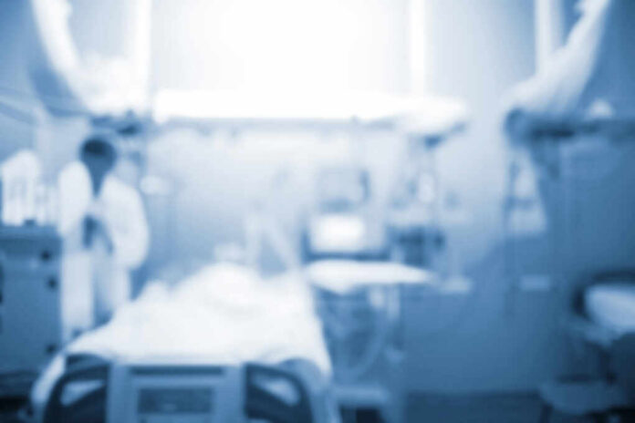 shutterstock_1107771344 Blurred image of a medical professional in a hospital setting