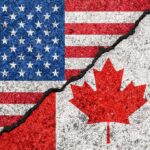 Trade War With Canada Intensifies Again USA and Canada flags with a cracked border
