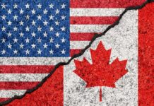 Trade War With Canada Intensifies Again USA and Canada flags with a cracked border