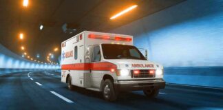 Man Linked To Epstein Found Dead Ambulance driving through a tunnel with emergency lights on