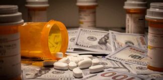 Budget Squeeze Coming For Medicare Drug Plans Prescription pill bottle and white tablets on scattered US dollar bills