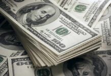 Fund Raid Sparks Fierce Backlash Stack of US 100 dollar bills