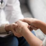 Probation Chaos Hid A Predator Doctor holding patient’s hands in support