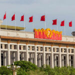 China Blasts Trump’s Russia Tariff Bill Facade of the National Museum of China adorned with red flags and decorative elements