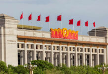 China Blasts Trump’s Russia Tariff Bill Facade of the National Museum of China adorned with red flags and decorative elements