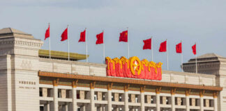 China Blasts Trump’s Russia Tariff Bill Facade of the National Museum of China adorned with red flags and decorative elements