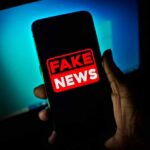 Elite Murder Tale Exposed As Total Fake Smartphone screen showing a bold fake news warning