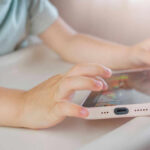 Can Governments Control Streaming? Childs hands interacting with a tablet on a table
