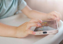 Can Governments Control Streaming? Childs hands interacting with a tablet on a table