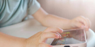 Can Governments Control Streaming? Childs hands interacting with a tablet on a table