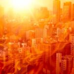 West Faces Relentless Heat Dome City skyline under intense heat with flames overlay