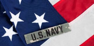 Close-up of an American flag with a U.S. Navy insignia