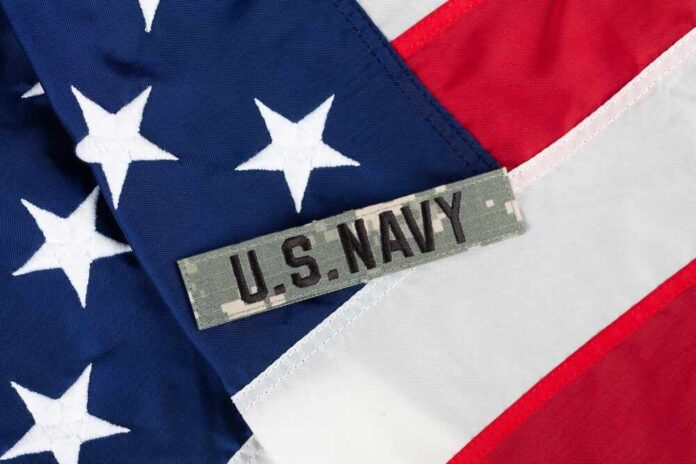 Us,Navy,Branch,Tape,On,National,Usa,Flag,Background Close-up of an American flag with a U.S. Navy insignia