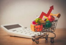 Inflation Slows, Costs Still Bite A shopping cart filled with colorful grocery items next to a calculator and an upward trend arrow