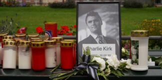Charlie Kirk Case Enters Critical Phase Memorial setup with candles, flowers, and a framed photograph