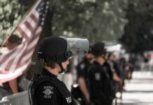 police officer in riot gear standing in a line