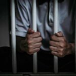 California’s Quiet Parole Loophole? person gripping prison bars