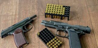 Texas Judge Deals Major Blow To NFA Two handguns and boxes of ammunition on a wooden floor