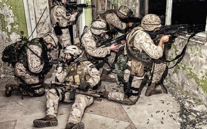 soldiers in camouflage gear take positions inside a damaged building