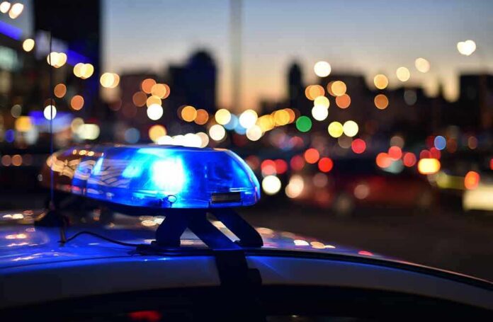 shutterstock_1164796372 Police car light bar flashing at dusk