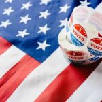 Trump Elector Case Ends With Judge’s Ruling Roll of I Voted stickers on an American flag