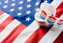Roll of I Voted stickers on an American flag