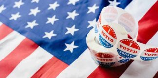 Roll of I Voted stickers on an American flag