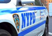 NYPD police car side with blue stripes and emblem