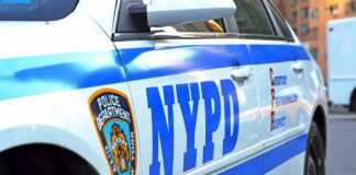 NYPD police car side with blue stripes and emblem