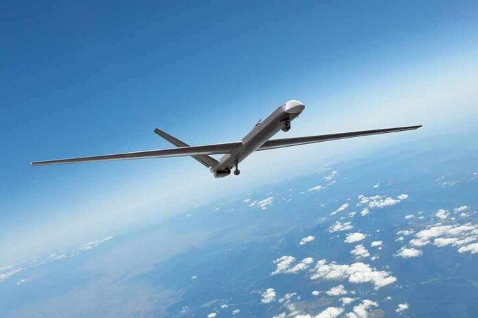 Unmanned aerial drone flying high above clouds
