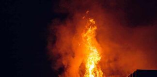 Wildfire Carnage Tied To Ex-Con? House roof engulfed in flames at night