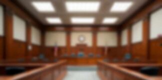 Empty courtroom with wooden benches and judge's bench