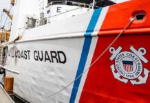 Whistleblower Clash Inside Coast Guard US Coast Guard ship hull with emblem and red stripe