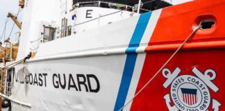 Whistleblower Clash Inside Coast Guard US Coast Guard ship hull with emblem and red stripe