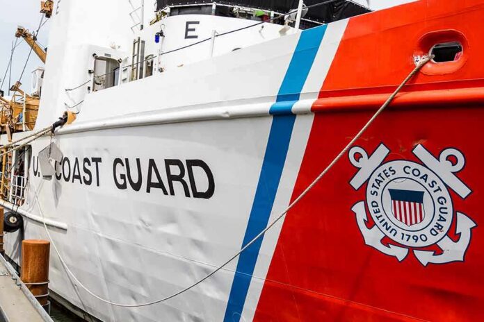 shutterstock_498768505 US Coast Guard ship hull with emblem and red stripe