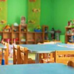 Parents Blindsided By Home Daycare Nightmare Preschool classroom with small tables and wooden chairs