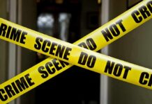 2-Year-Old Boy Murdered by His Mom Yellow crime scene tape crossing a doorway