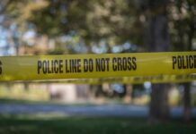 Staged Hanging Shocker Rattles Mississippi yellow police tape cordoning off an outdoor area