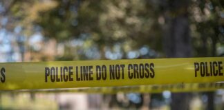 Staged Hanging Shocker Rattles Mississippi yellow police tape cordoning off an outdoor area