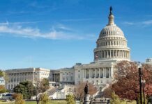 United States Capitol building with dome and autumn trees