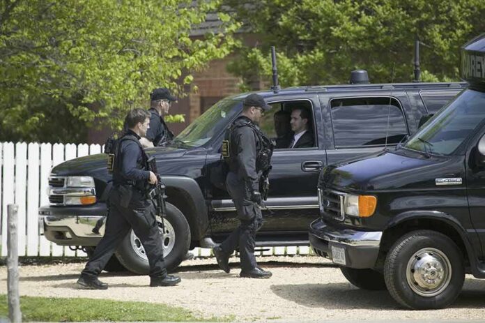 Alex Blumberg in SUV as armed security officers walk by