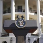 Presidential podium with seal in front of white-columned building