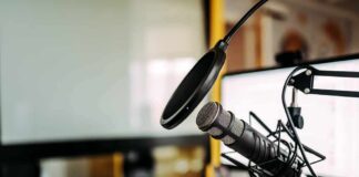 Podcast microphone with pop filter on desk