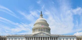 United States Capitol building with dome under a blue sky