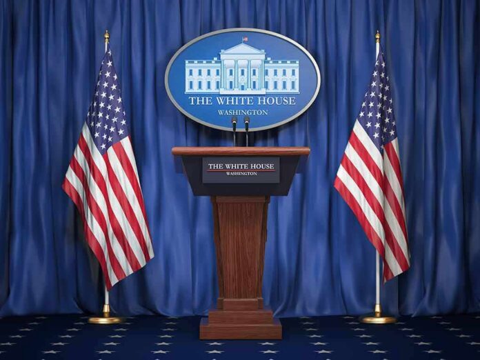shutterstock_1159933525-2 White House press podium with microphones and two American flags
