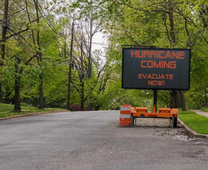 Portable electronic road sign on a quiet tree-lined street