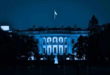 The White House at night with blue lighting