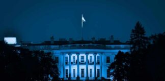 The White House at night with blue lighting