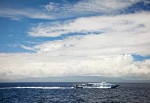 Storm Horror: Hundreds Vanish At Sea White passenger boat cruising on open sea under cloudy sky