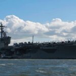 Aircraft carrier at sea with fighter jets on deck